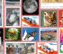 Diverse collection of colorful US postage stamps featuring various themes like space, animals, and vehicles.