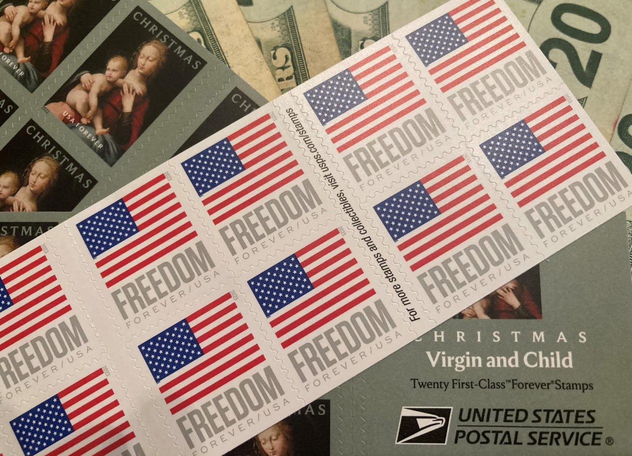 Sheets of U.S. 'Freedom' and 'Christmas' discount stamps on a money background.