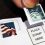 Hand holds Statue of Liberty stamp over envelope. Explore options to reuse stamps for mailing.