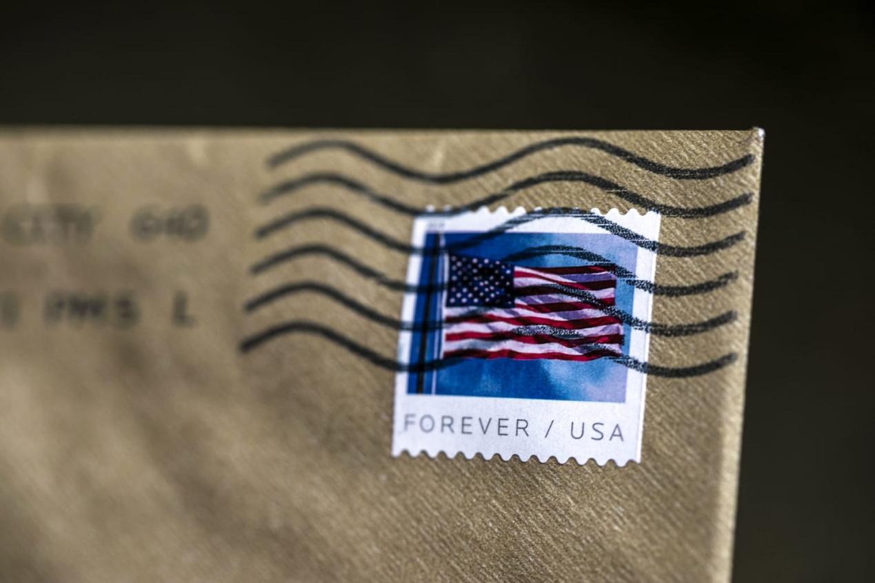 US flag Forever stamp postmarked on an envelope, excellent for finding discount stamps.